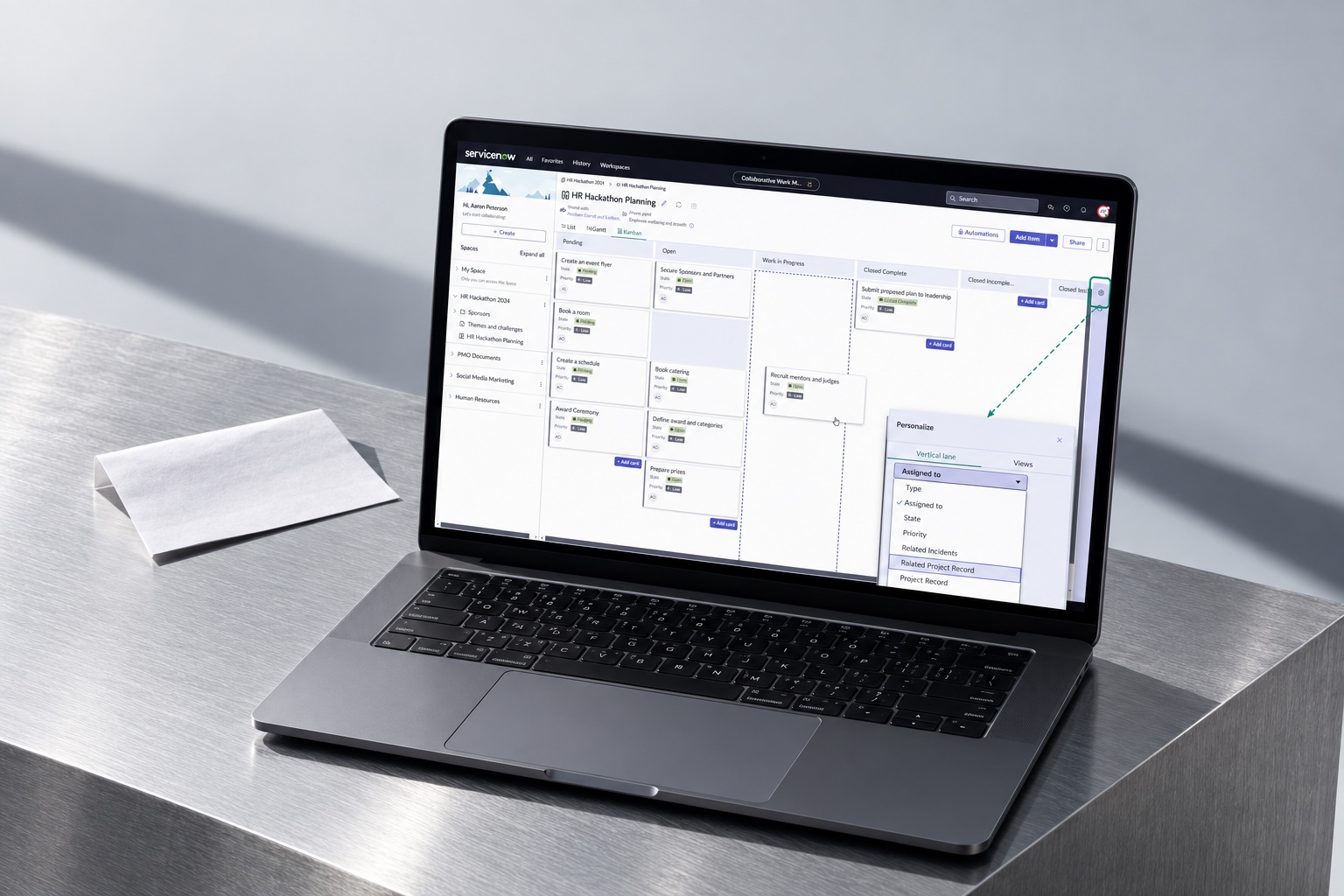 Collaborative Work Management on a graphite laptop in a daylight aluminum studio