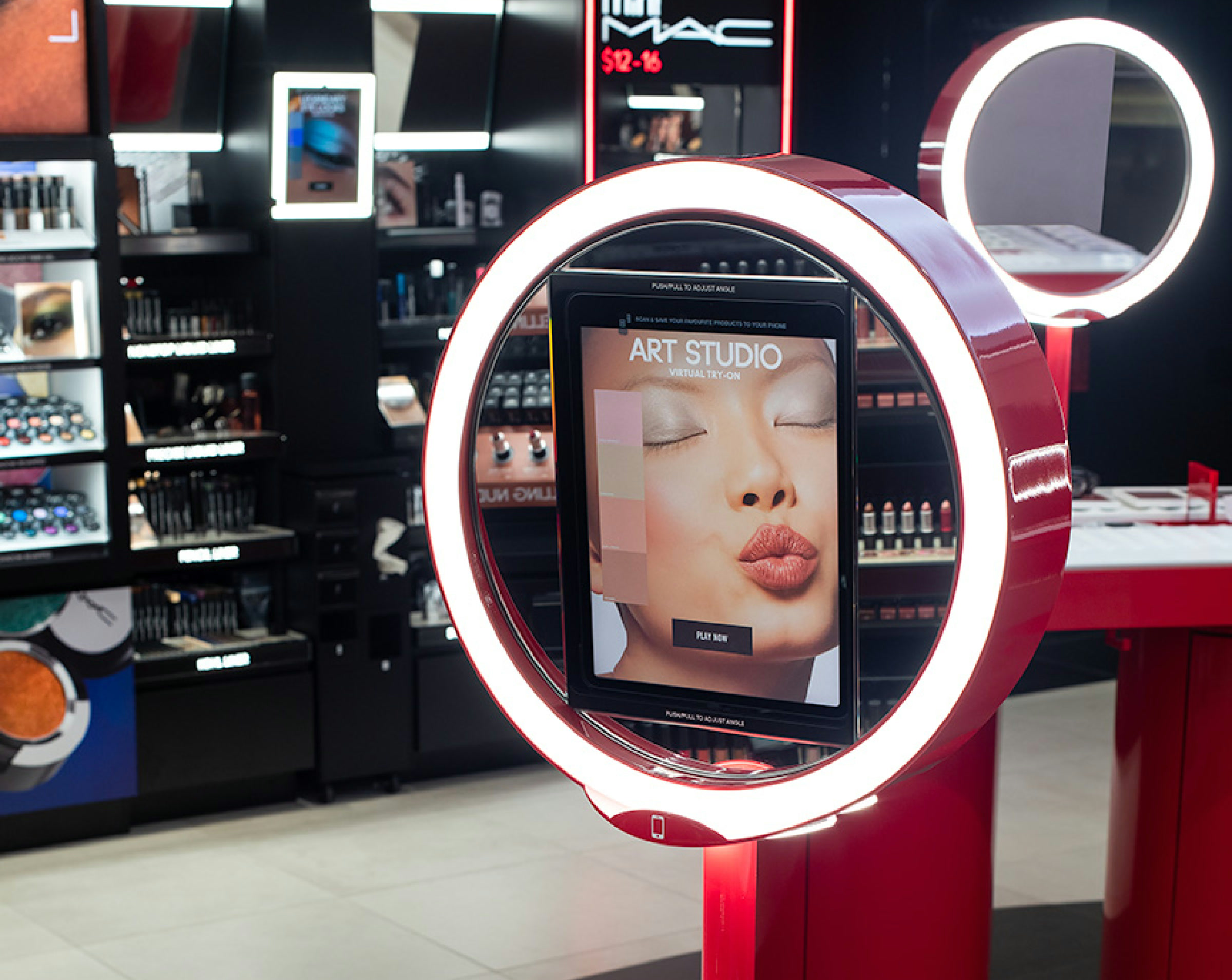 Circular red Art Studio station with an integrated iPad inside the MAC concept store
