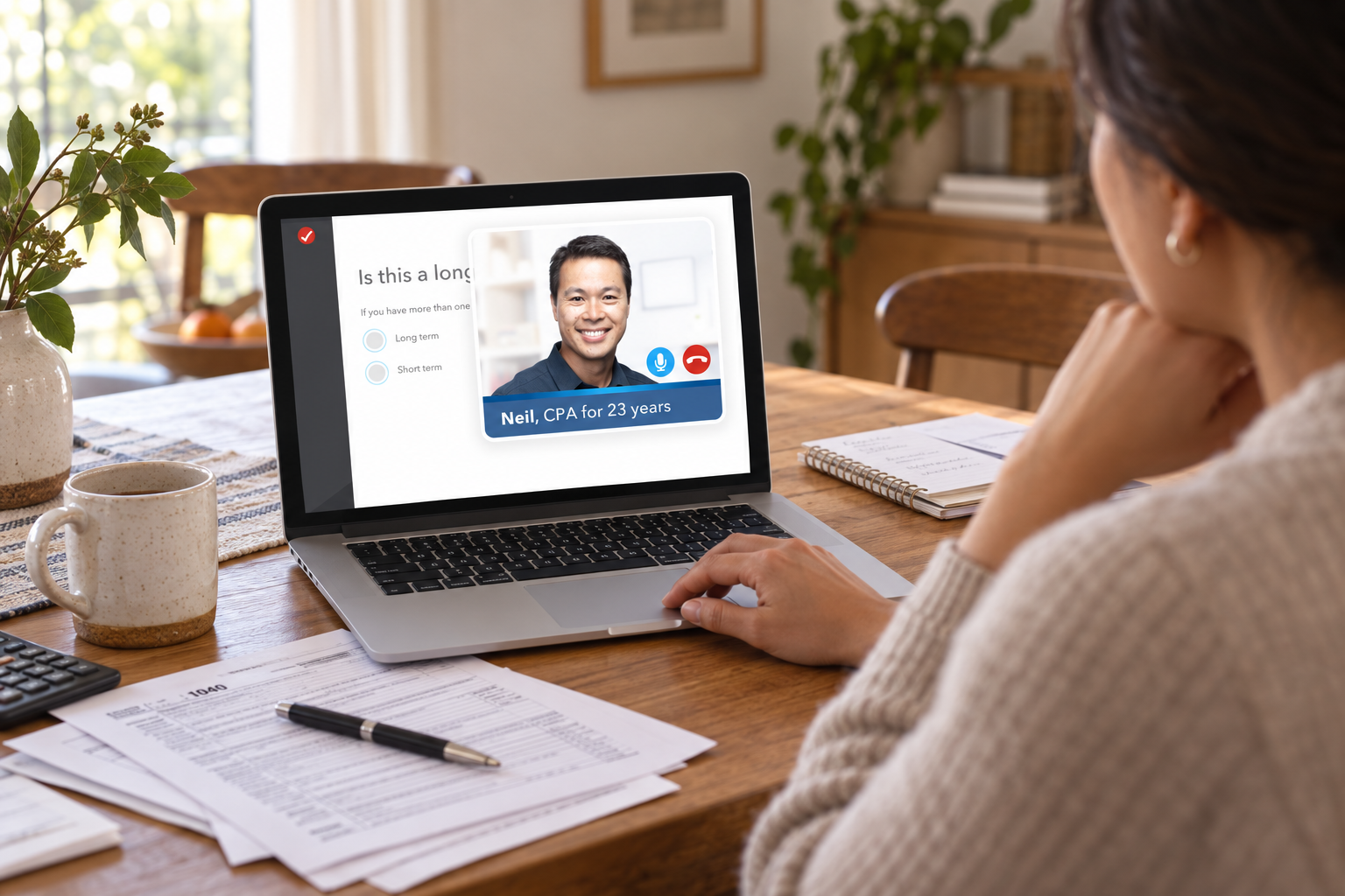 Customer filing taxes at home with a TurboTax Live expert visible on the laptop
